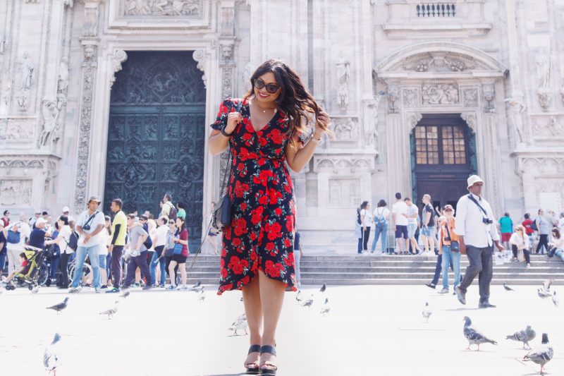 Fashion blogger outside of Duomo di Milano wearing a rose printed summer dress from Primark, black and brown wedges from Vince Camuto and a Rebecca Minkoff handbag.