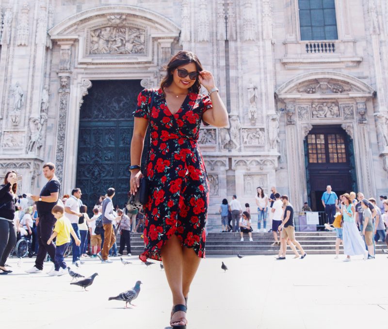Fashion blogger outside of Duomo di Milano wearing a rose printed summer dress from Primark, black and brown wedges from Vince Camuto and a Rebecca Minkoff handbag.